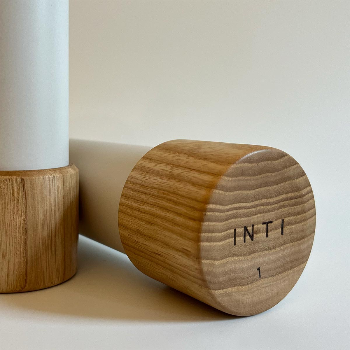 1kg INTI dumbbell closeup. Ash Wood and cast stone end detail.