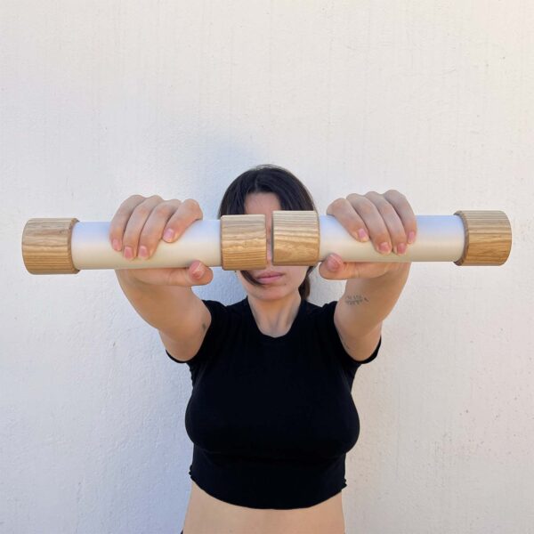 Girl modelling 1.5kg / 3lb luxury dumbbells made from natural ash wood and cast stone composite.